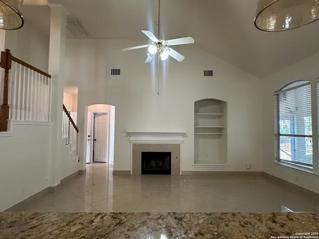 a view of a livingroom with a fireplace and window