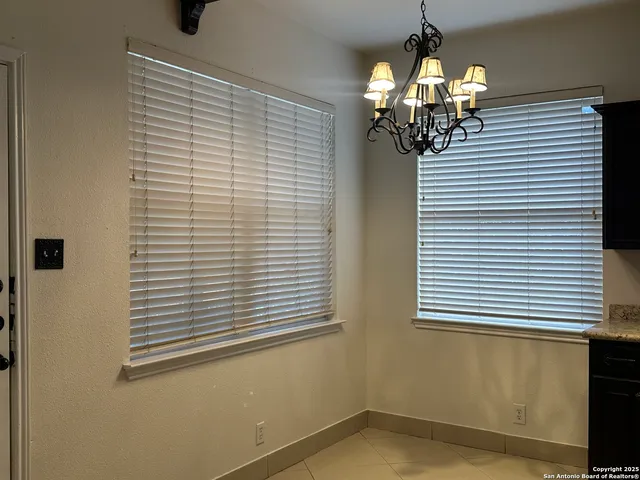 a view of a room that has a window and a chandelier