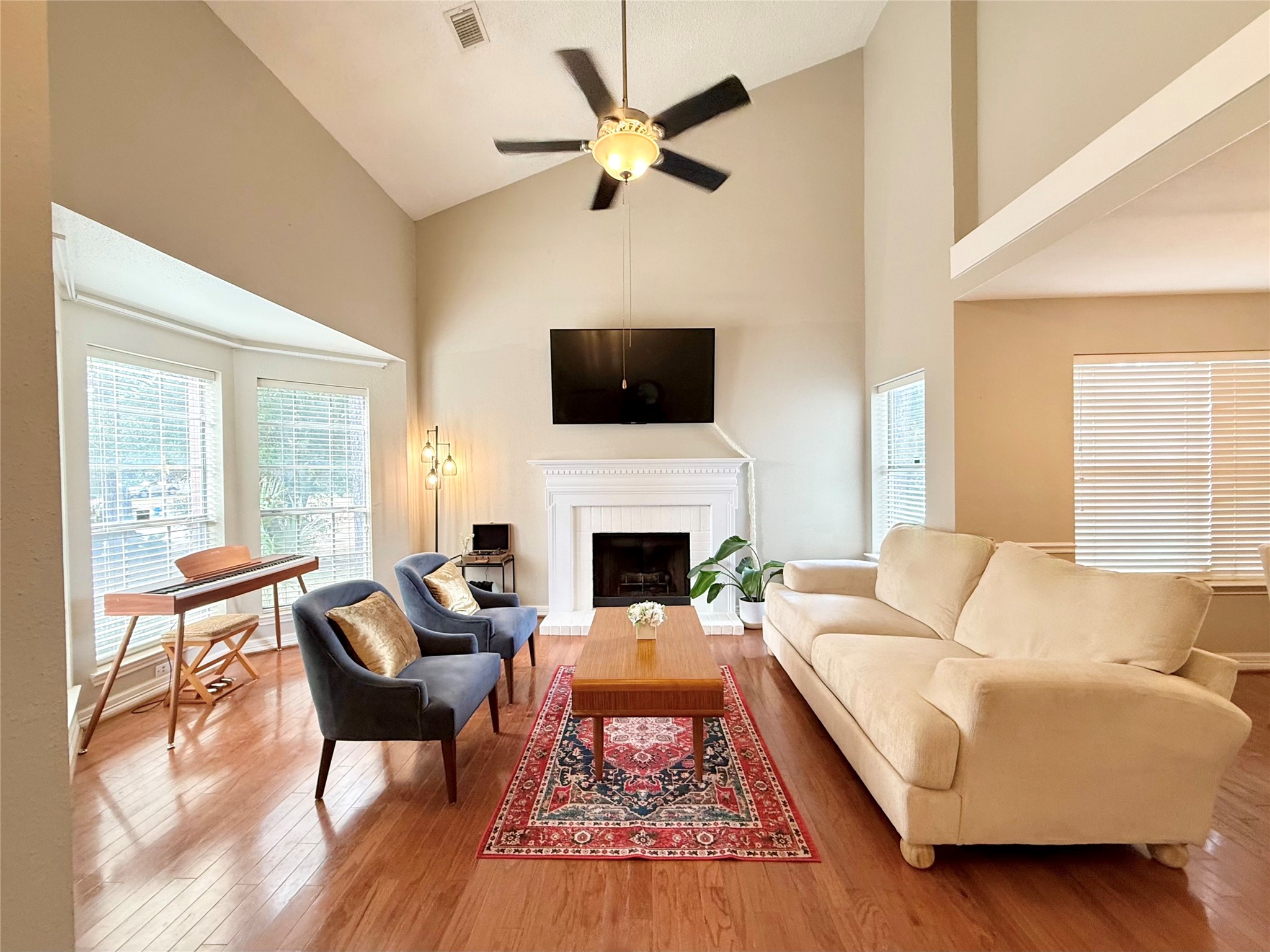 16902 Colony Creek Drive Spring, TX 77379 - Photo 2 of 18 a living room with furniture a flat screen tv and a fireplace