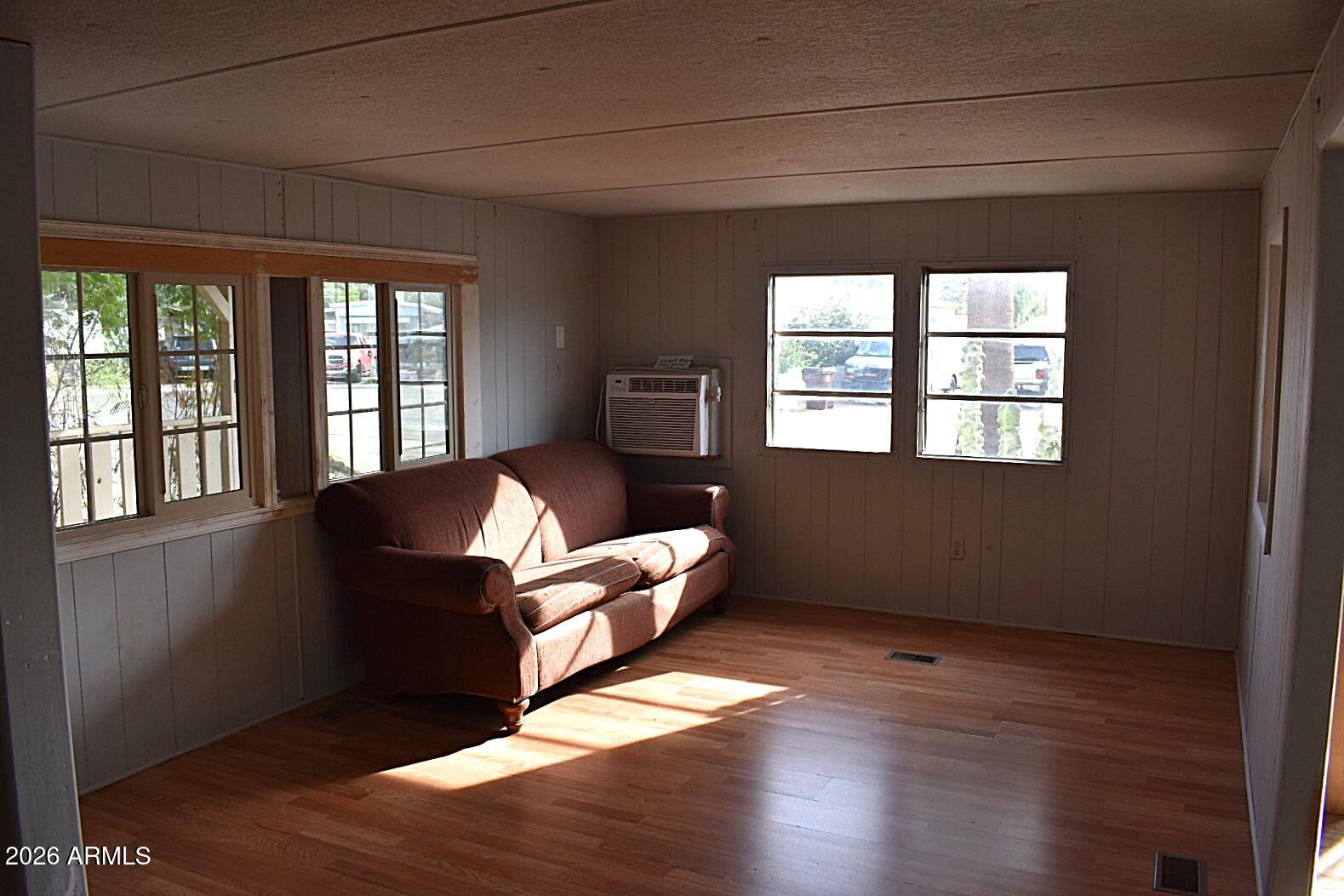 8138 Butte Street Mesa, AZ 85207 - Photo 3 of 27 a living room with a couch wooden floor and a window
