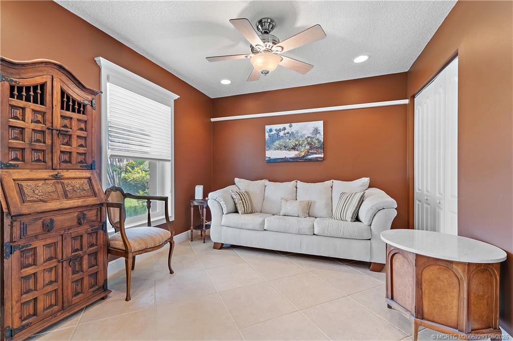 815 Southwest Rustic Circle Stuart, FL 34997 - Photo 11 of 20 a living room with furniture and a painting