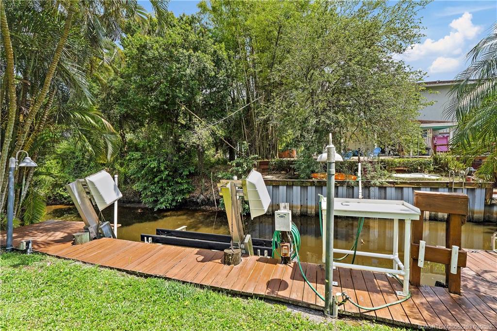 815 Southwest Rustic Circle Stuart, FL 34997 - Photo 16 of 20 a view of a chairs and table in the back yard