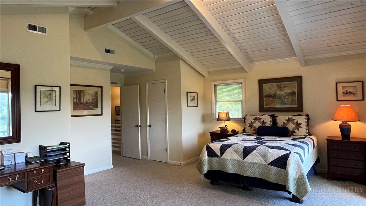 638 Ridge Road Glade Valley, NC 28627 - Photo 33 of 44 a spacious bedroom with a bed and wooden floor