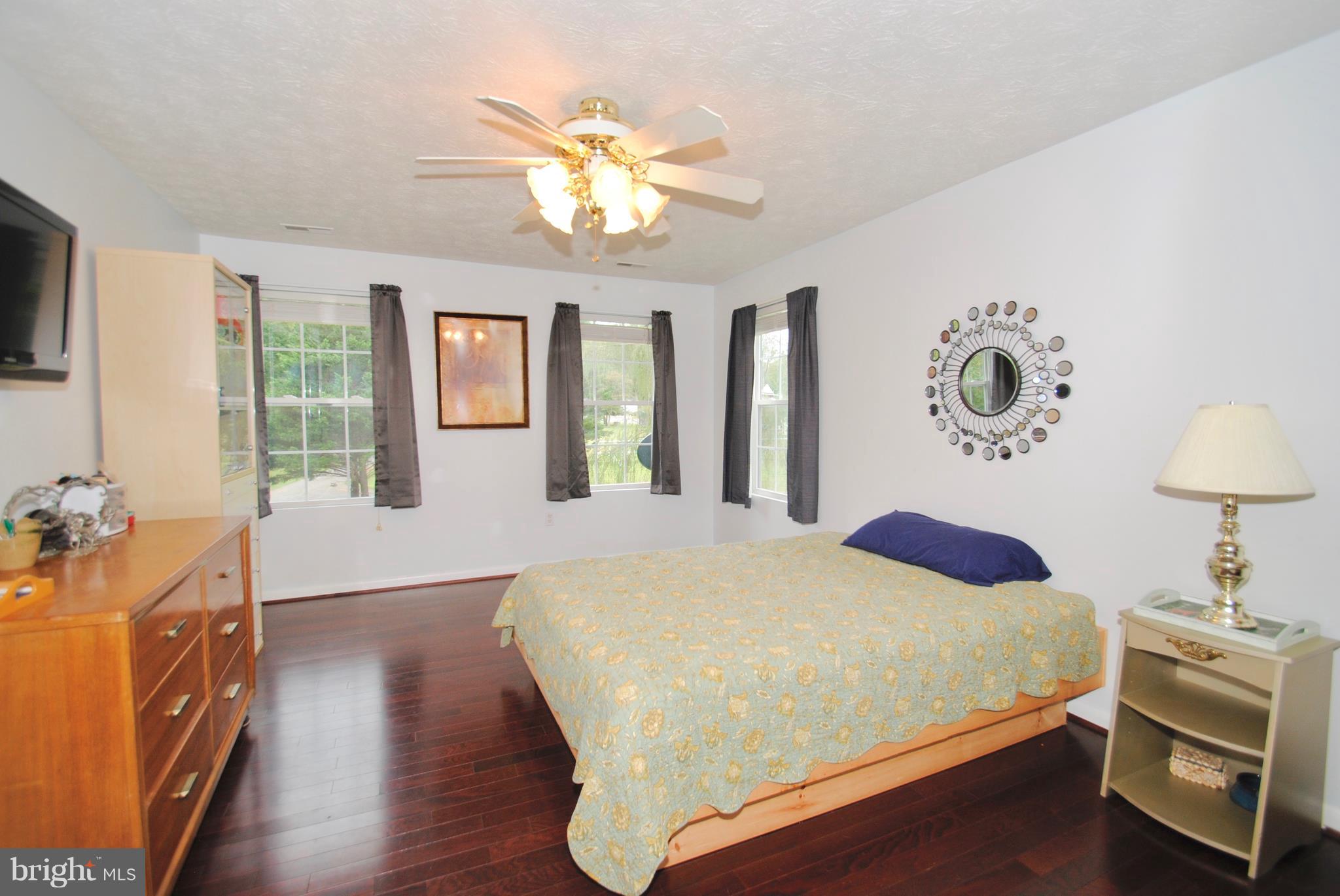 302 Fairhaven Road Tracys Landing, MD 20779 - Photo 11 of 24 a bedroom with a bed and a chandelier