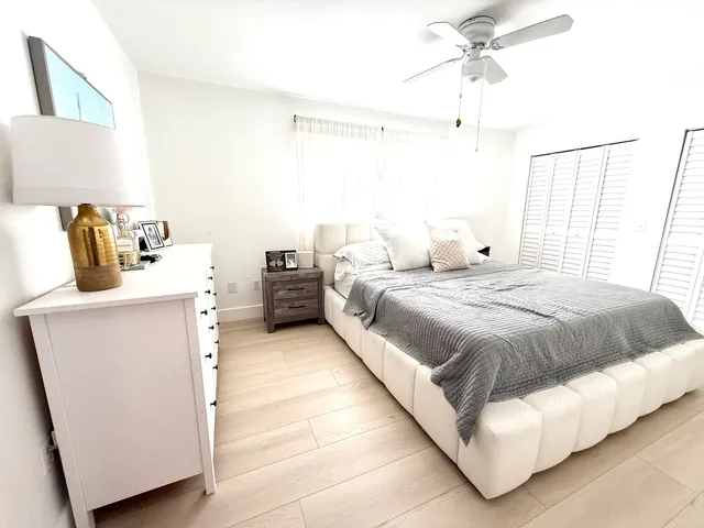 a bedroom with bed and window