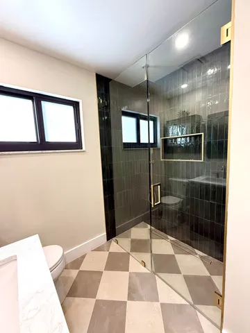 a bathroom with a glass shower door