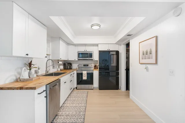 a kitchen with stainless steel appliances granite countertop a refrigerator and a sink