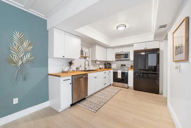 a kitchen with stainless steel appliances granite countertop a refrigerator sink and cabinets
