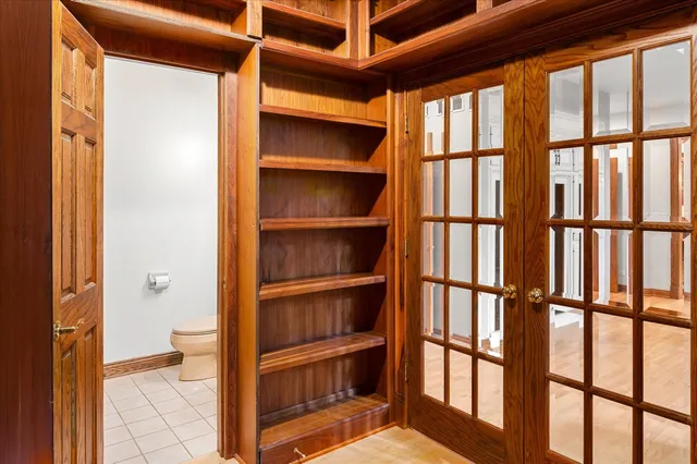 a bedroom with furniture and large window
