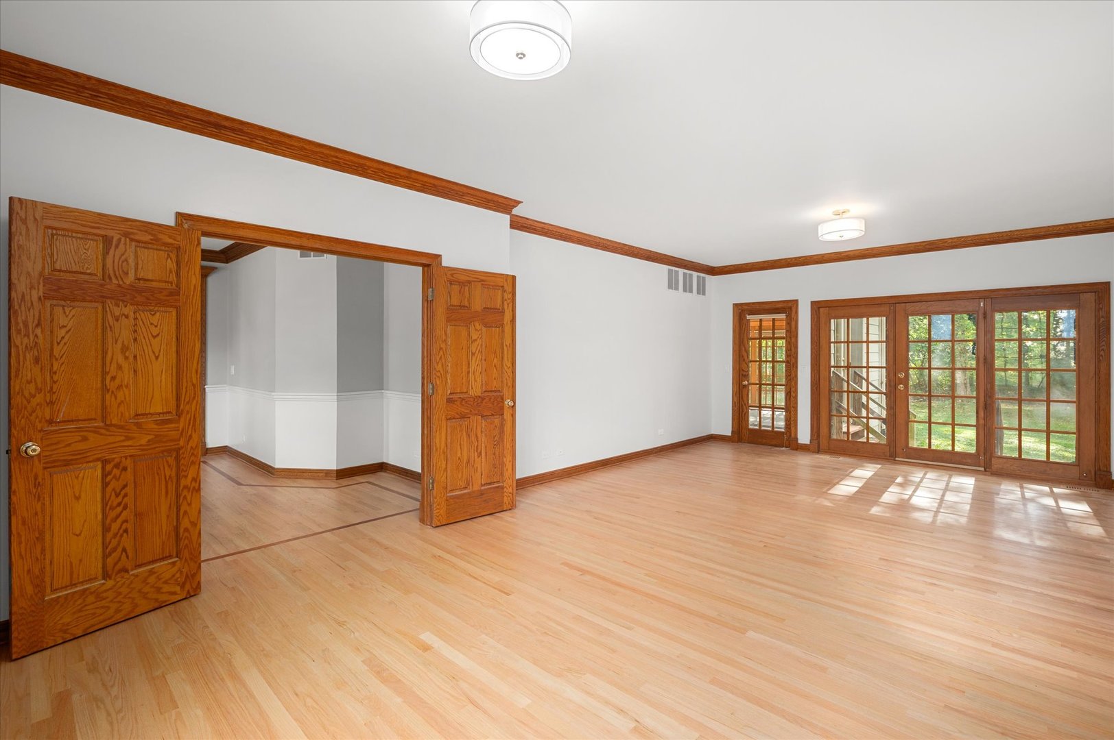 5N847 Surrey Road Wayne, IL 60184 - Photo 19 of 45 a view of an empty room with wooden floor and a window