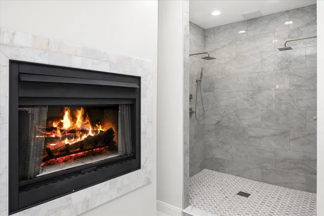 a bathroom with a granite countertop toilet a sink a mirror and a window