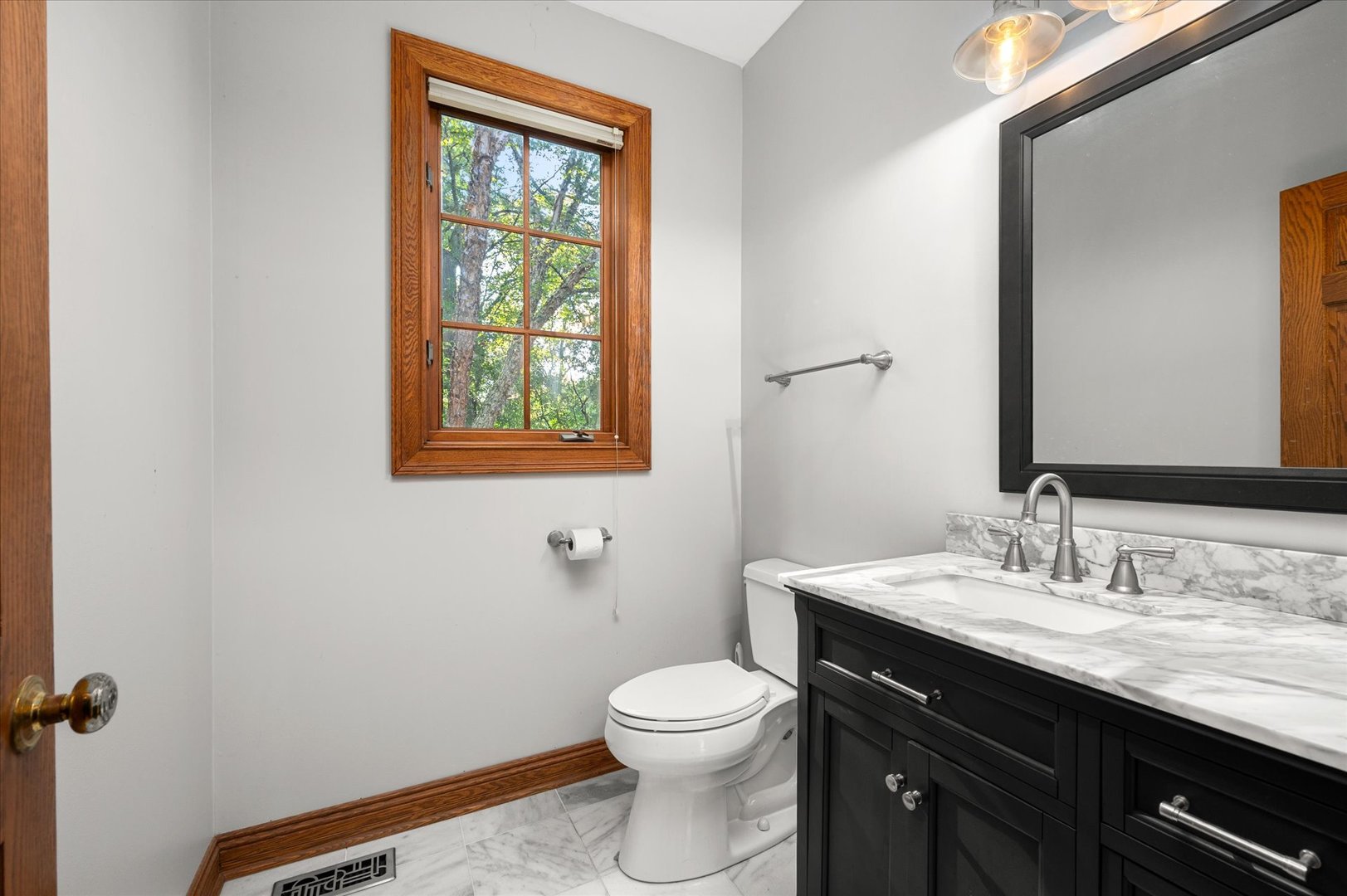 5N847 Surrey Road Wayne, IL 60184 - Photo 24 of 45 a bathroom with a granite countertop toilet a sink a mirror and a window