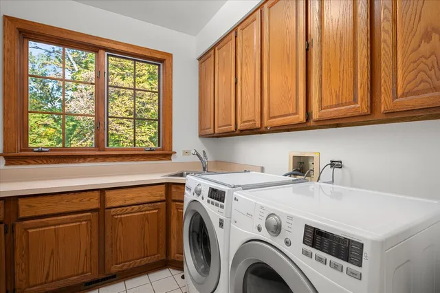 a view of staircase with railing and a chandelier