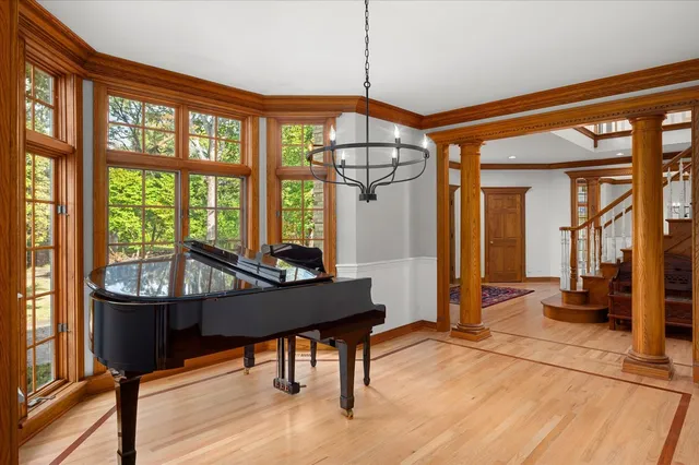 a living room with fireplace furniture and a large window