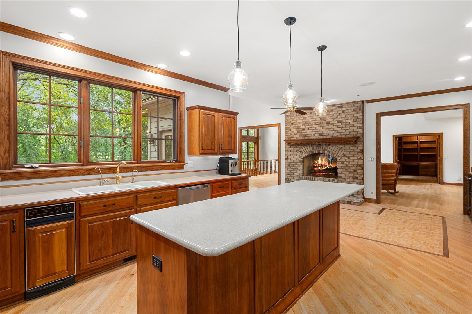 5N847 Surrey Road Wayne, IL 60184 - Photo 10 of 45 a kitchen with a stove a sink a kitchen island a dining table and chairs