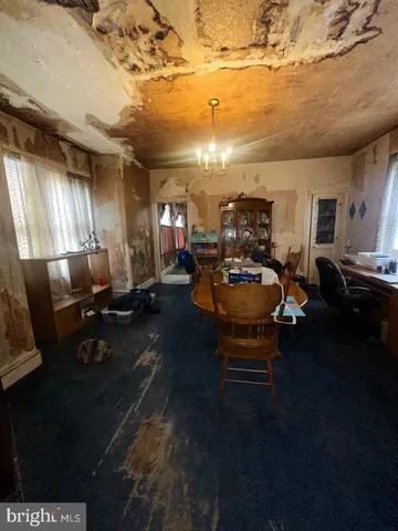 a bedroom with a bed next to a window