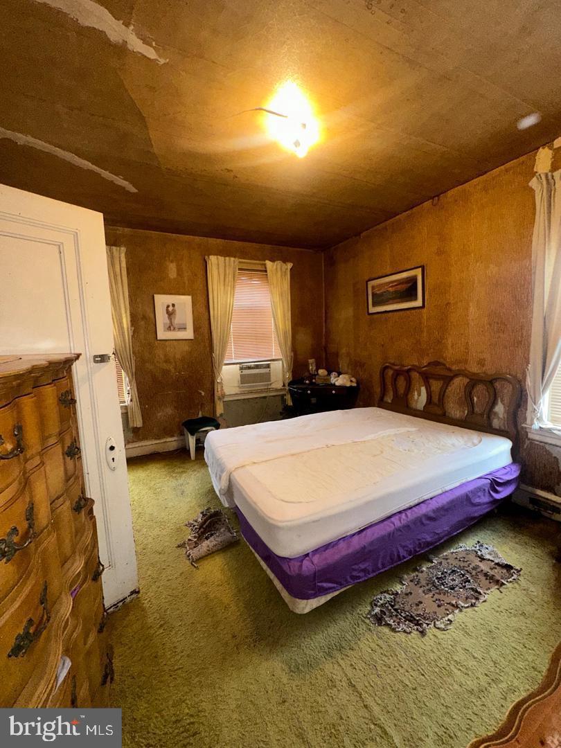 7538 Forrest Avenue Philadelphia, PA 19150 - Photo 16 of 16 a bed sitting in a spacious bedroom next to a window