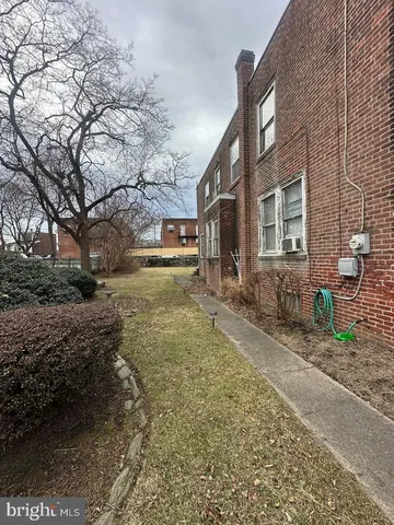 a pathway of a house with a yard