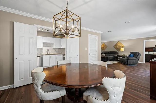 a view of a dining room with furniture wooden floor and chandelier