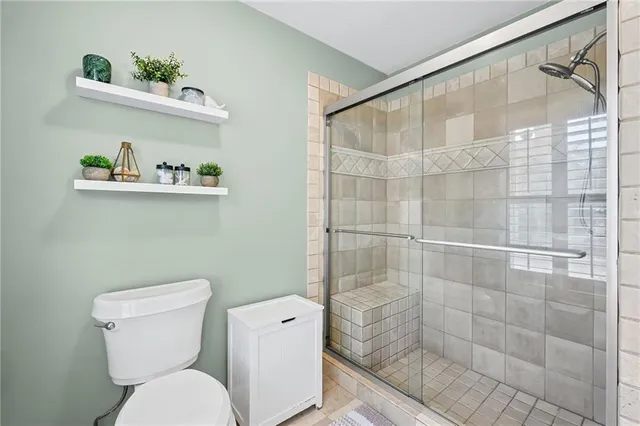 a bathroom with a toilet and a shower