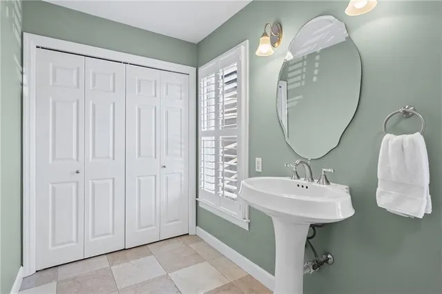 a bathroom with a sink a mirror and a light fixture