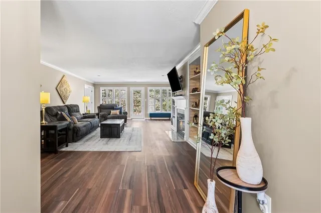 a living room with furniture a dining table and a potted plant