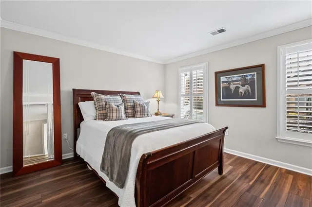 a bed sitting in a bedroom next to a window