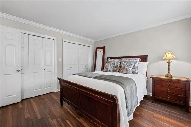 a bedroom with bed and wooden floor