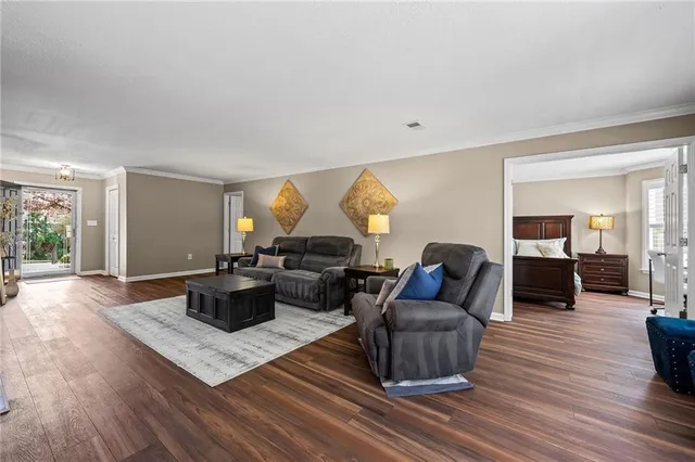 a living room with furniture and wooden floor