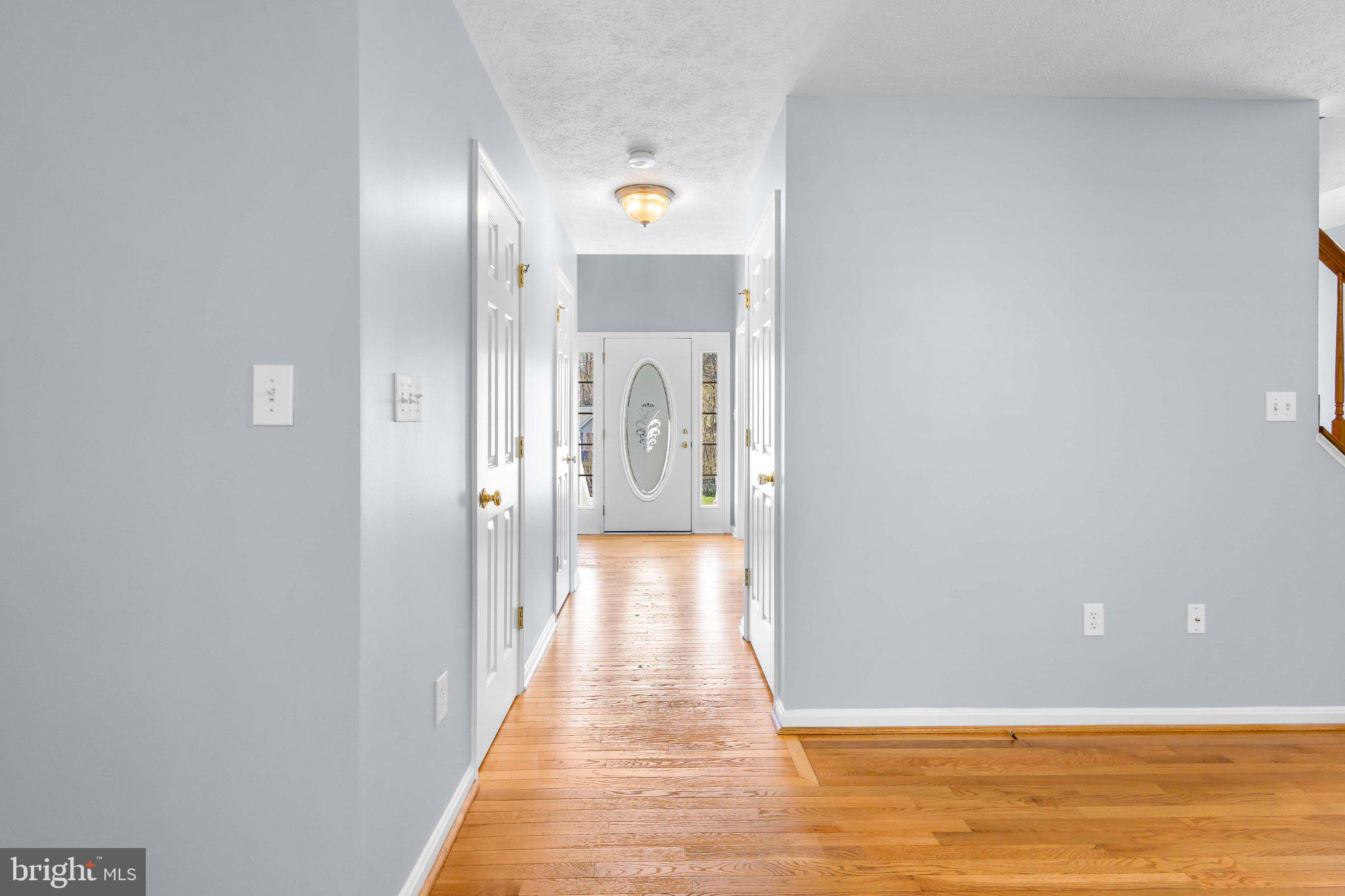 9084 Mullen Road King George, VA 22485 - Photo 12 of 41 Inviting hallway with warm wood floors.
