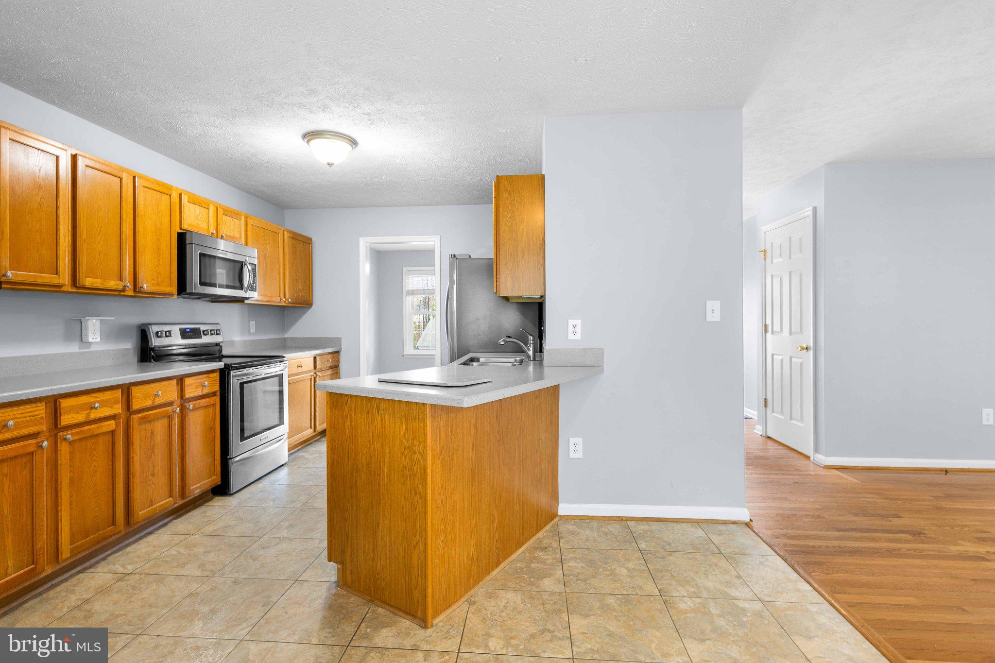 9084 Mullen Road King George, VA 22485 - Photo 13 of 41 Modern kitchen with warm wood accents.