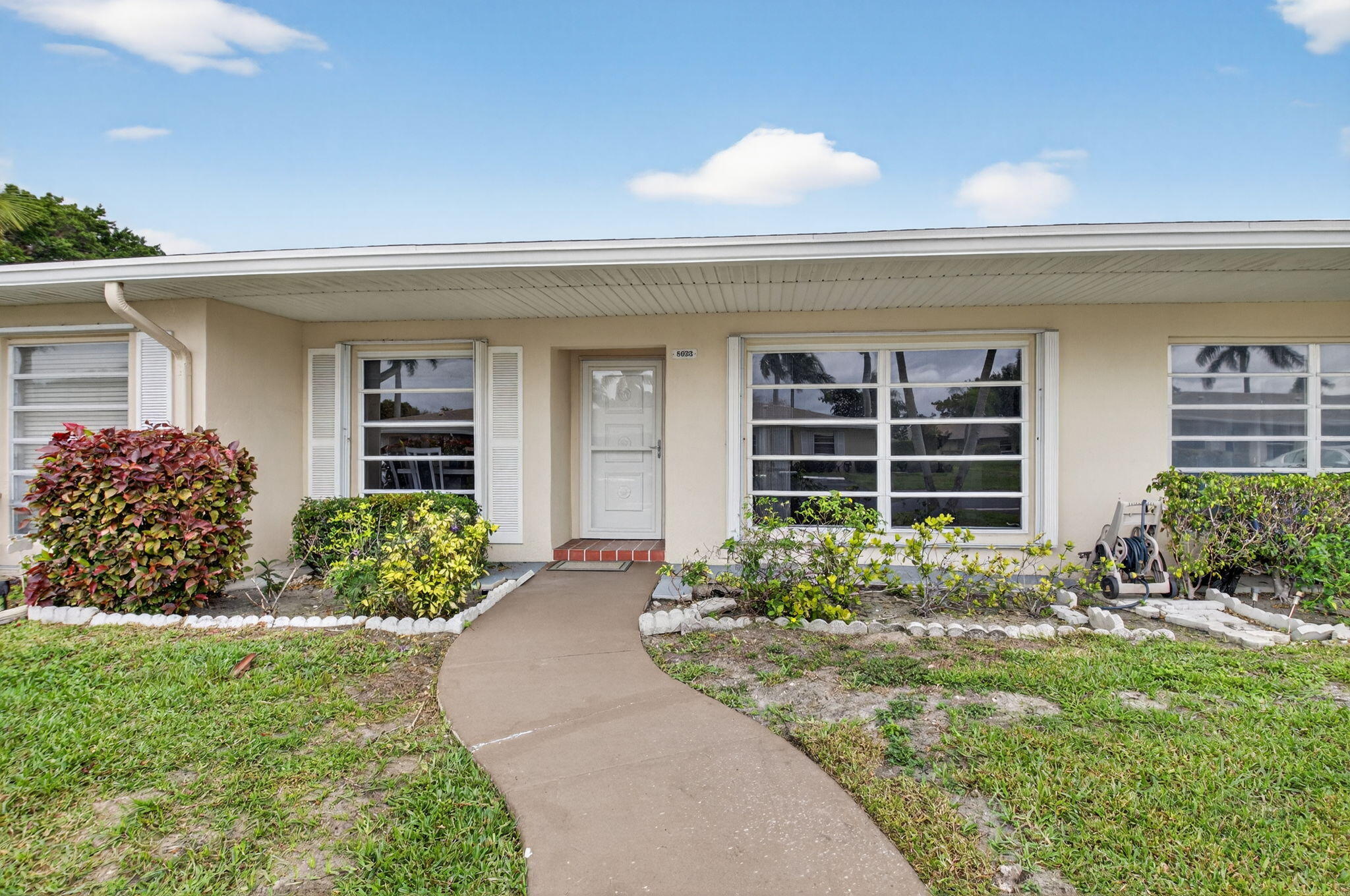 a front view of a house with garden