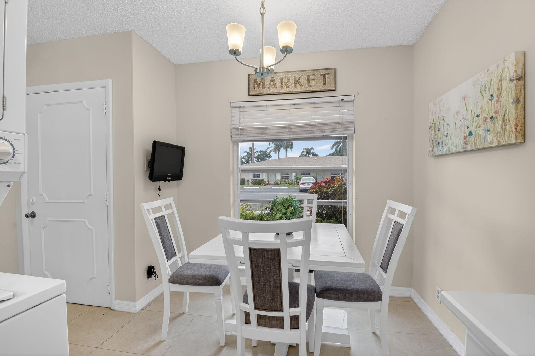 8633 Chevy Chase Drive Boca Raton, FL 33433 - Photo 13 of 43 a view of a dining room with furniture wooden floor and a chandelier