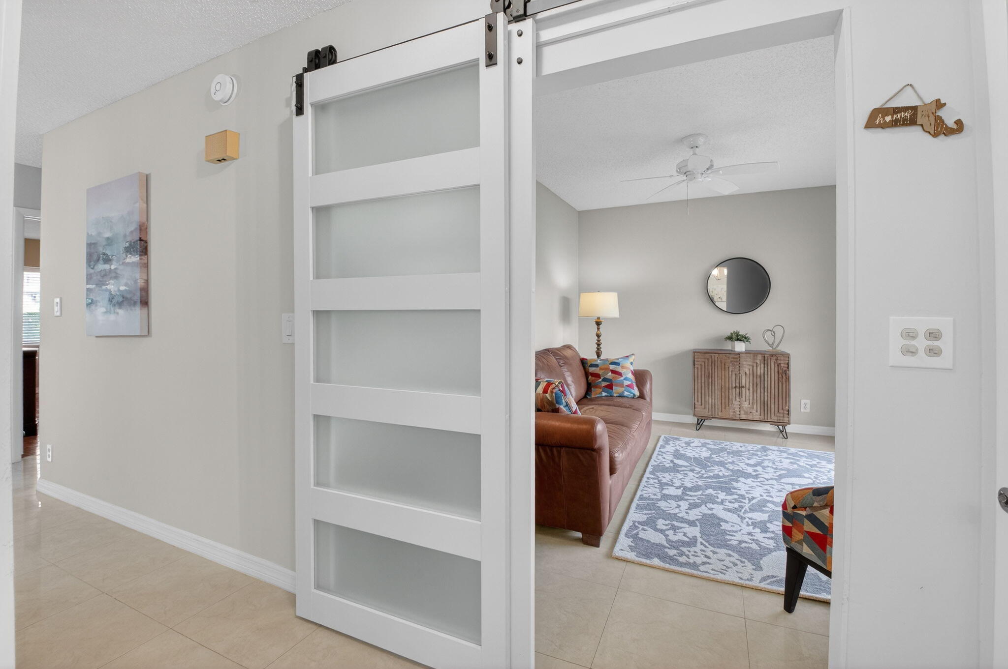 8633 Chevy Chase Drive Boca Raton, FL 33433 - Photo 14 of 43 a living room with furniture and a window