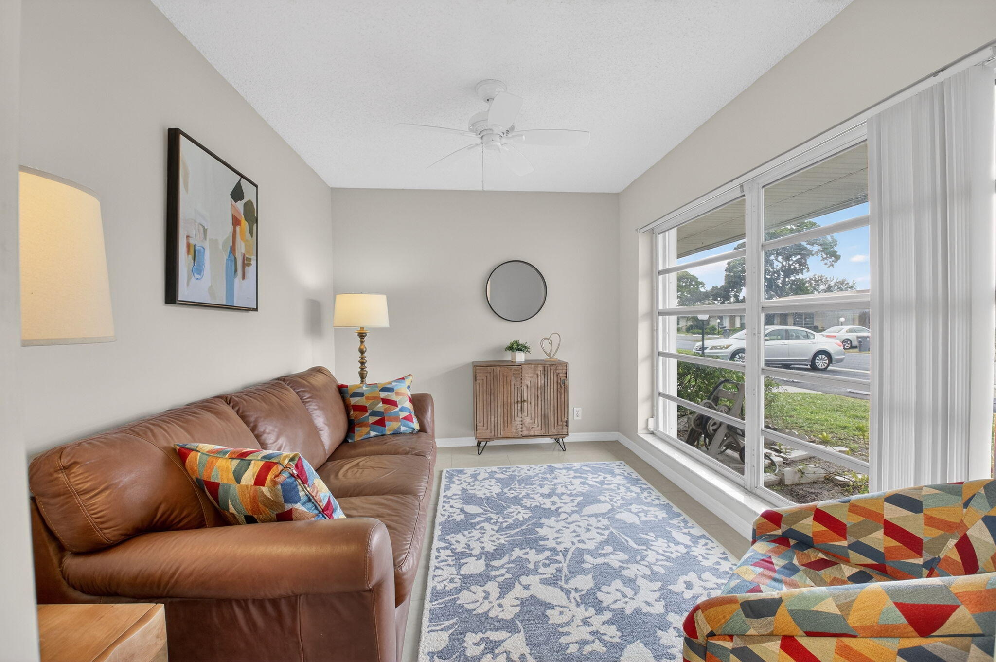 8633 Chevy Chase Drive Boca Raton, FL 33433 - Photo 15 of 43 a living room with furniture and a large window