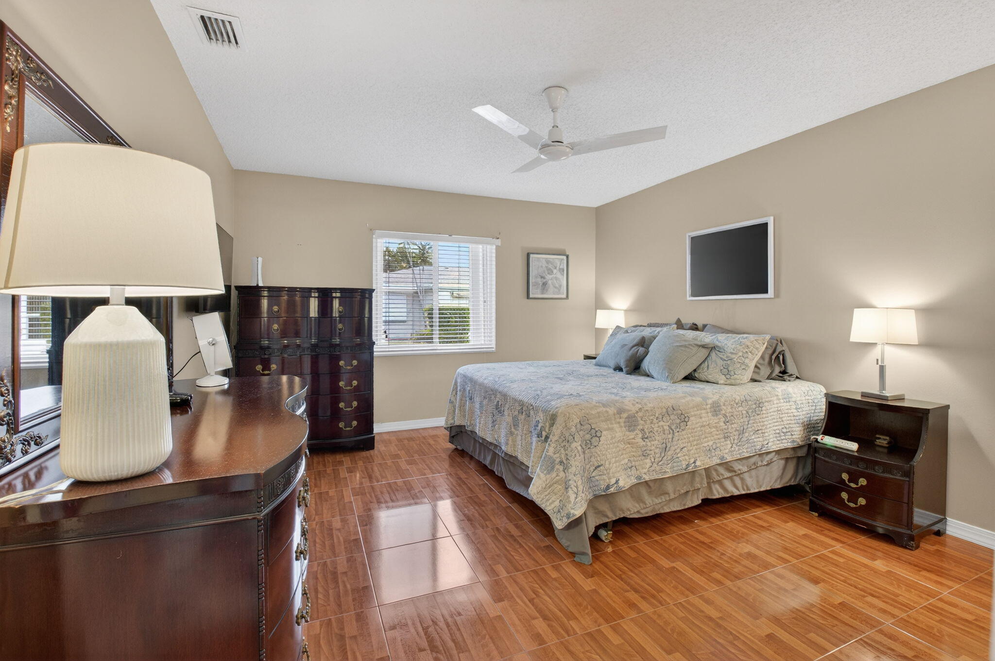 8633 Chevy Chase Drive Boca Raton, FL 33433 - Photo 17 of 43 a bedroom with a bed and dresser with mirror