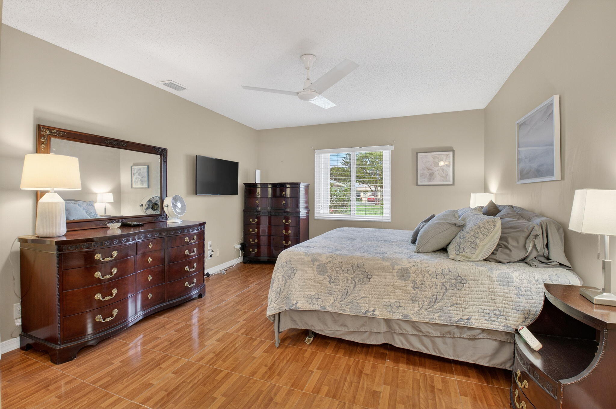 8633 Chevy Chase Drive Boca Raton, FL 33433 - Photo 18 of 43 a bedroom with a bed and a dresser