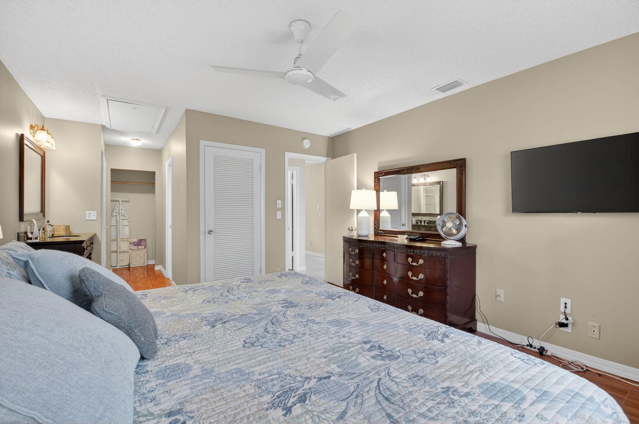 8633 Chevy Chase Drive Boca Raton, FL 33433 - Photo 19 of 43 a bedroom with a bed and a flat screen tv