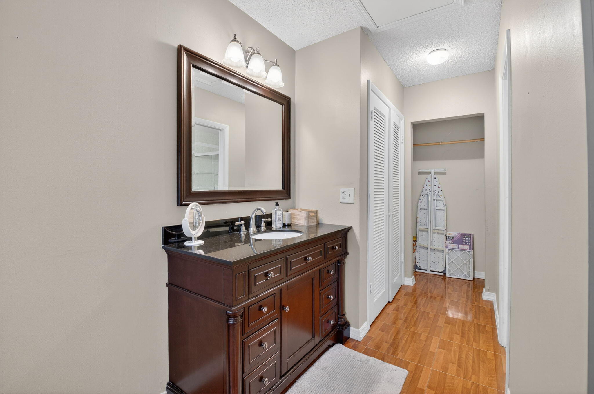 8633 Chevy Chase Drive Boca Raton, FL 33433 - Photo 20 of 43 a bathroom with a sink a mirror and a vanity