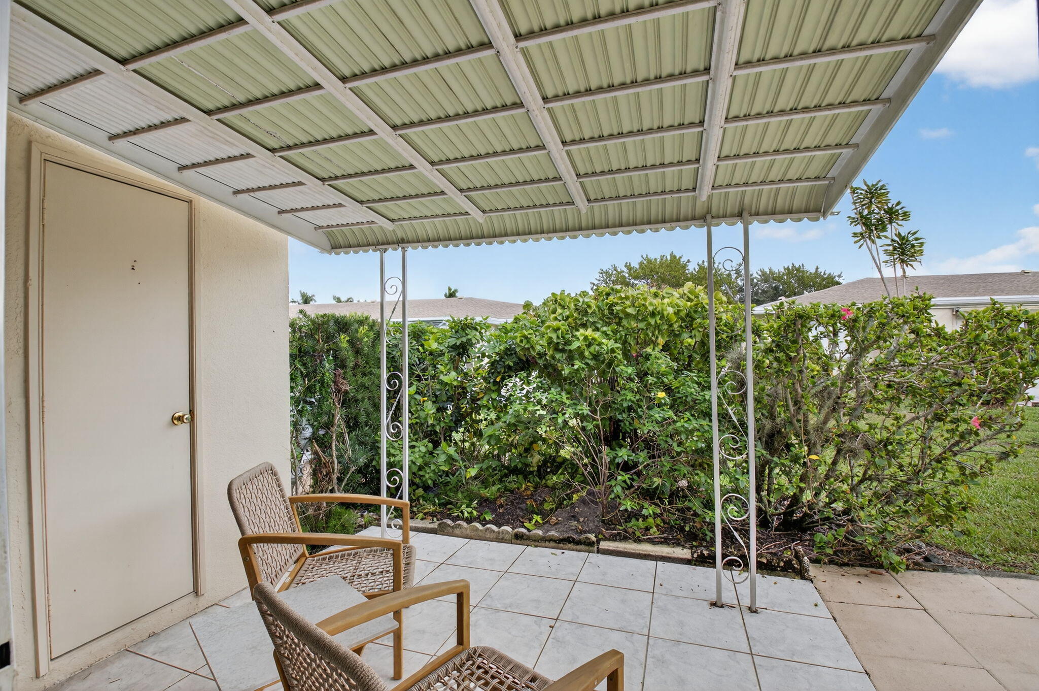 8633 Chevy Chase Drive Boca Raton, FL 33433 - Photo 23 of 43 a backyard with plants and outdoor seating