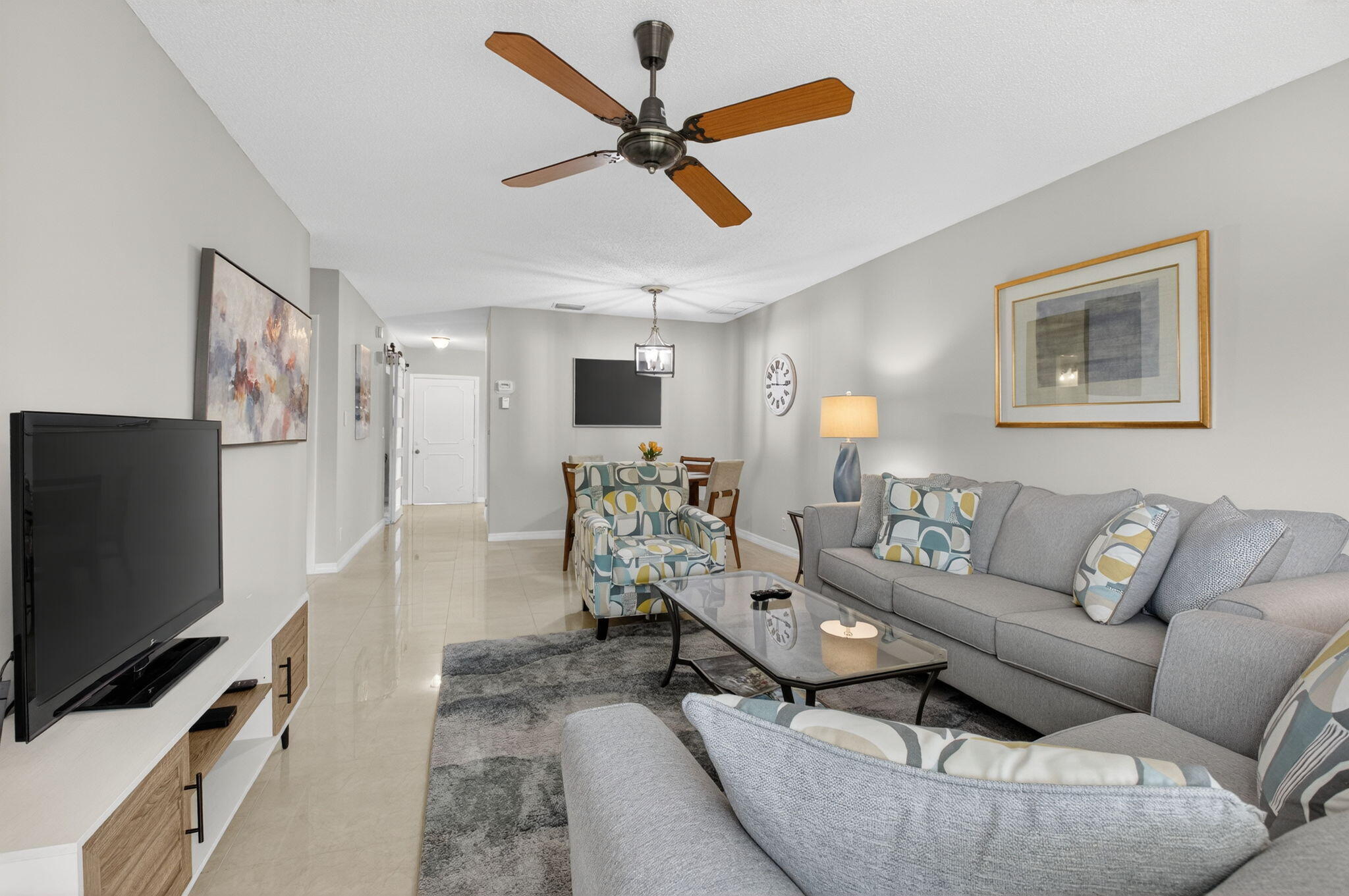 8633 Chevy Chase Drive Boca Raton, FL 33433 - Photo 6 of 43 a living room with furniture and a flat screen tv