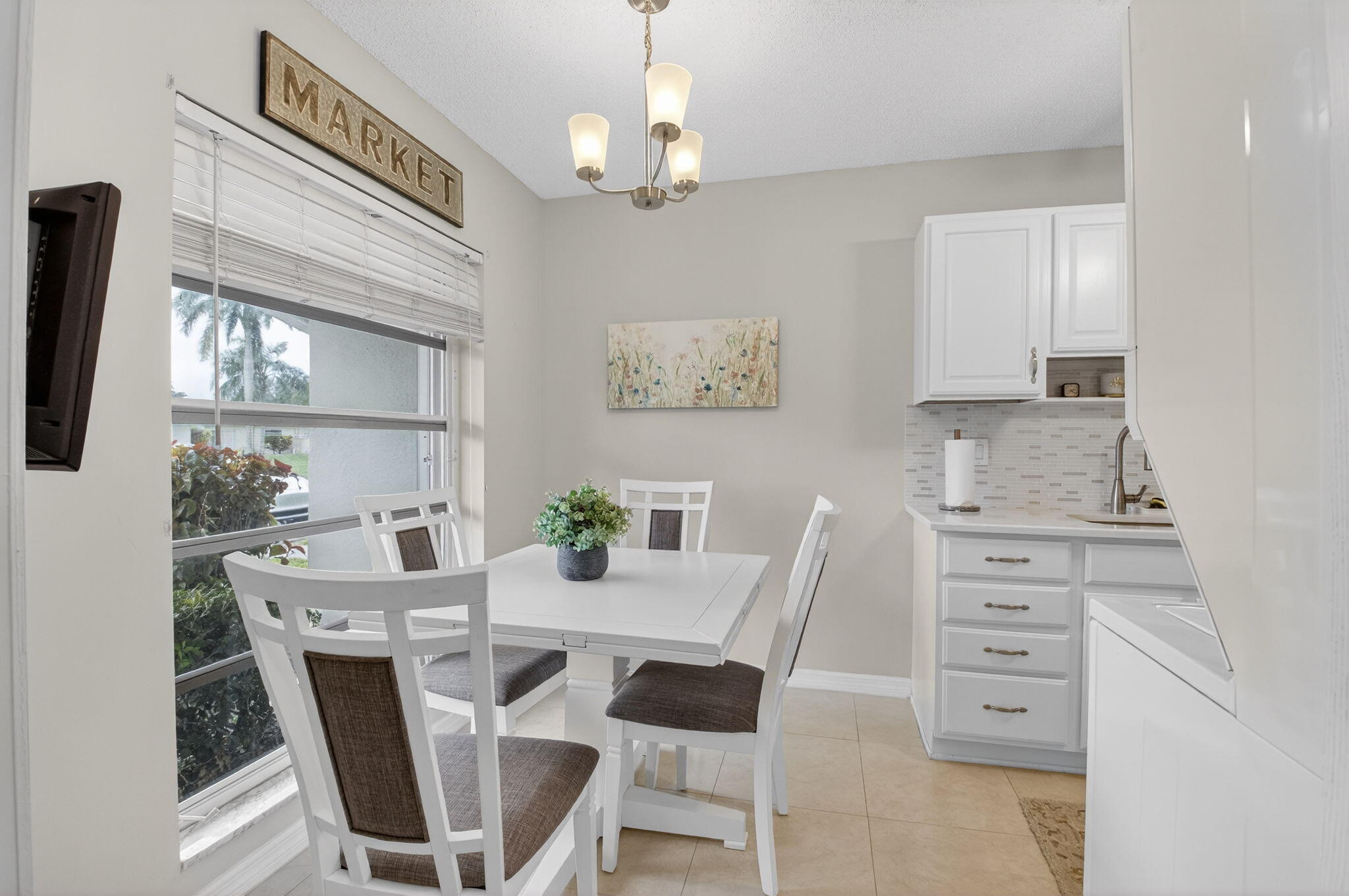 8633 Chevy Chase Drive Boca Raton, FL 33433 - Photo 7 of 43 a view of a dining room with furniture and chandelier