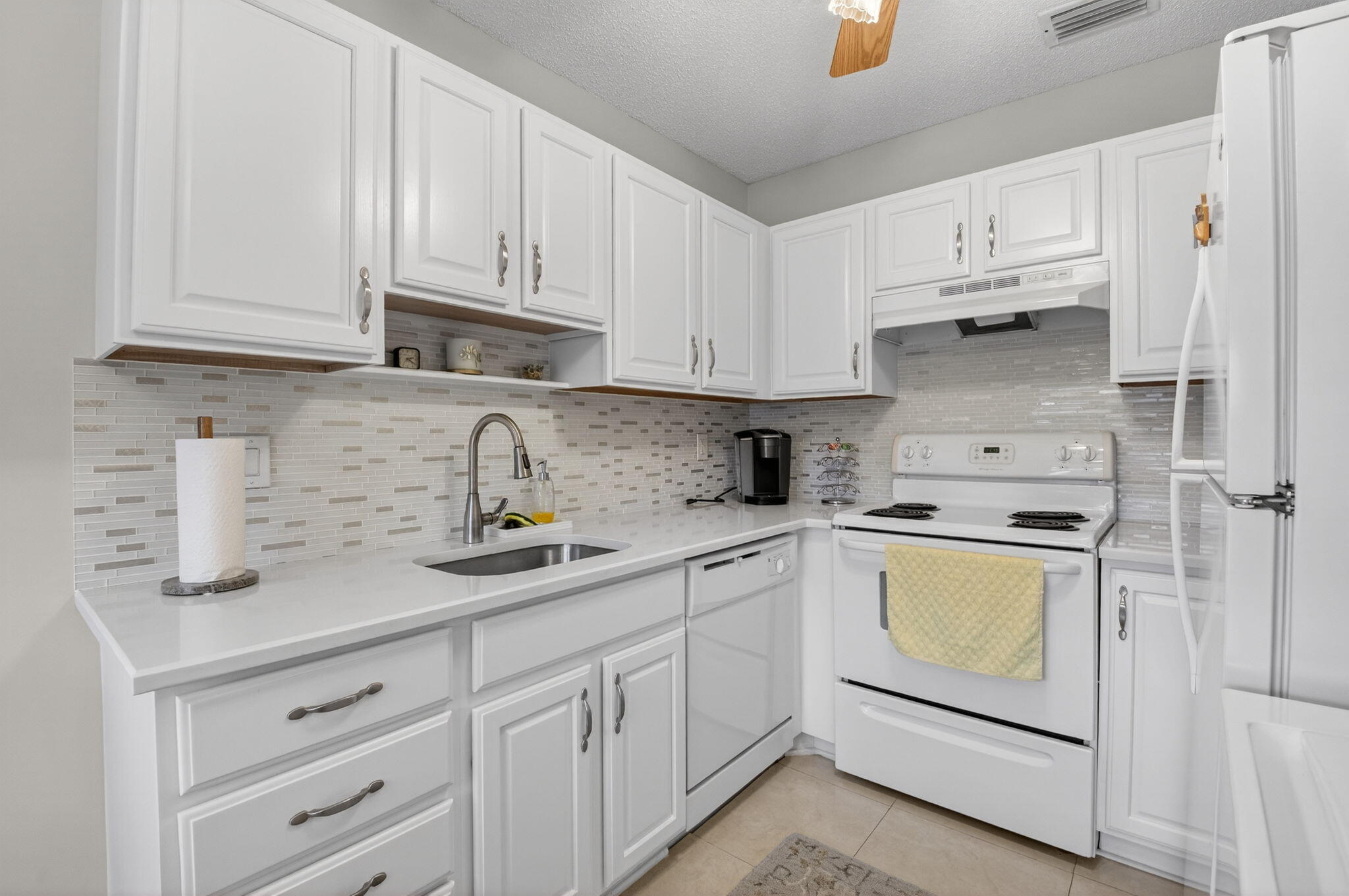 8633 Chevy Chase Drive Boca Raton, FL 33433 - Photo 9 of 43 a kitchen with cabinets appliances a sink and a counter space