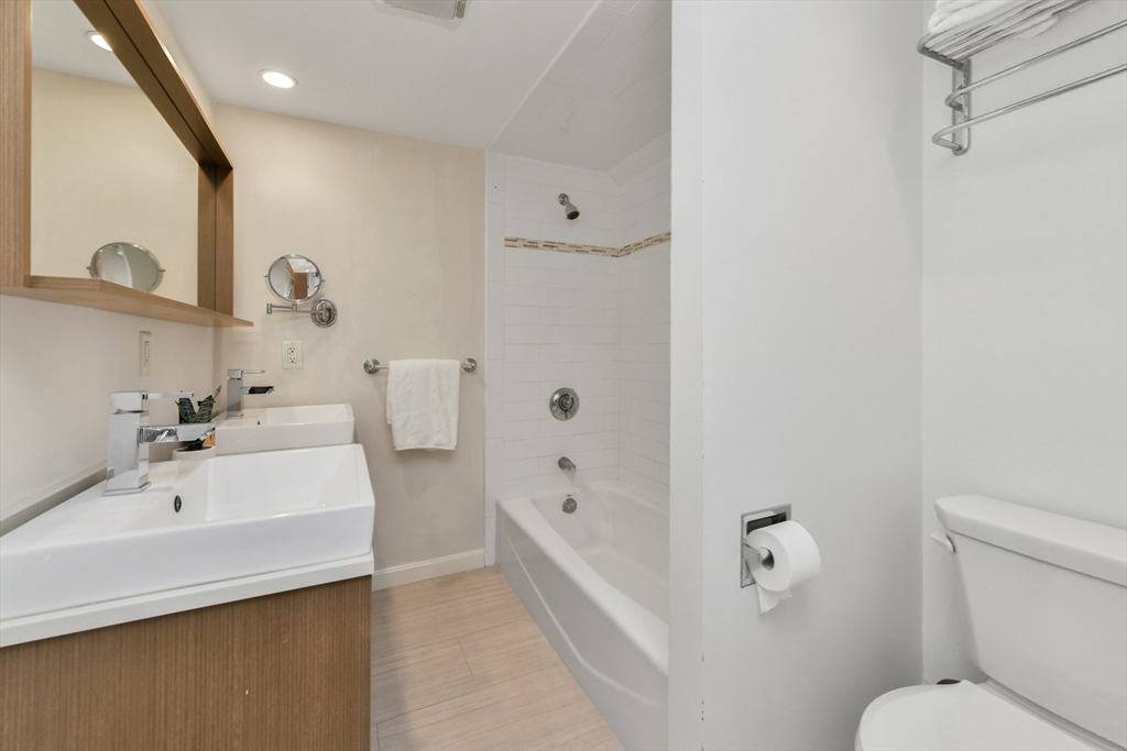 111 Inman Street, Unit A Cambridge, MA 02139 - Photo 15 of 18 a bathroom with a sink a toilet and shower