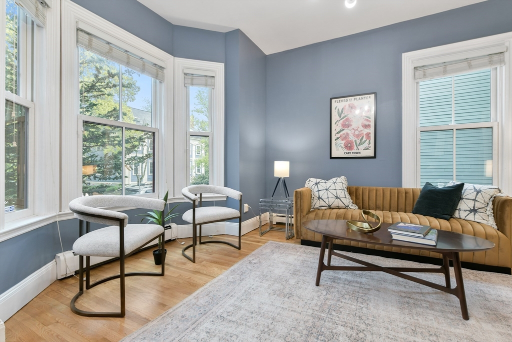 111 Inman Street, Unit A Cambridge, MA 02139 - Photo 4 of 18 a living room with furniture and a window