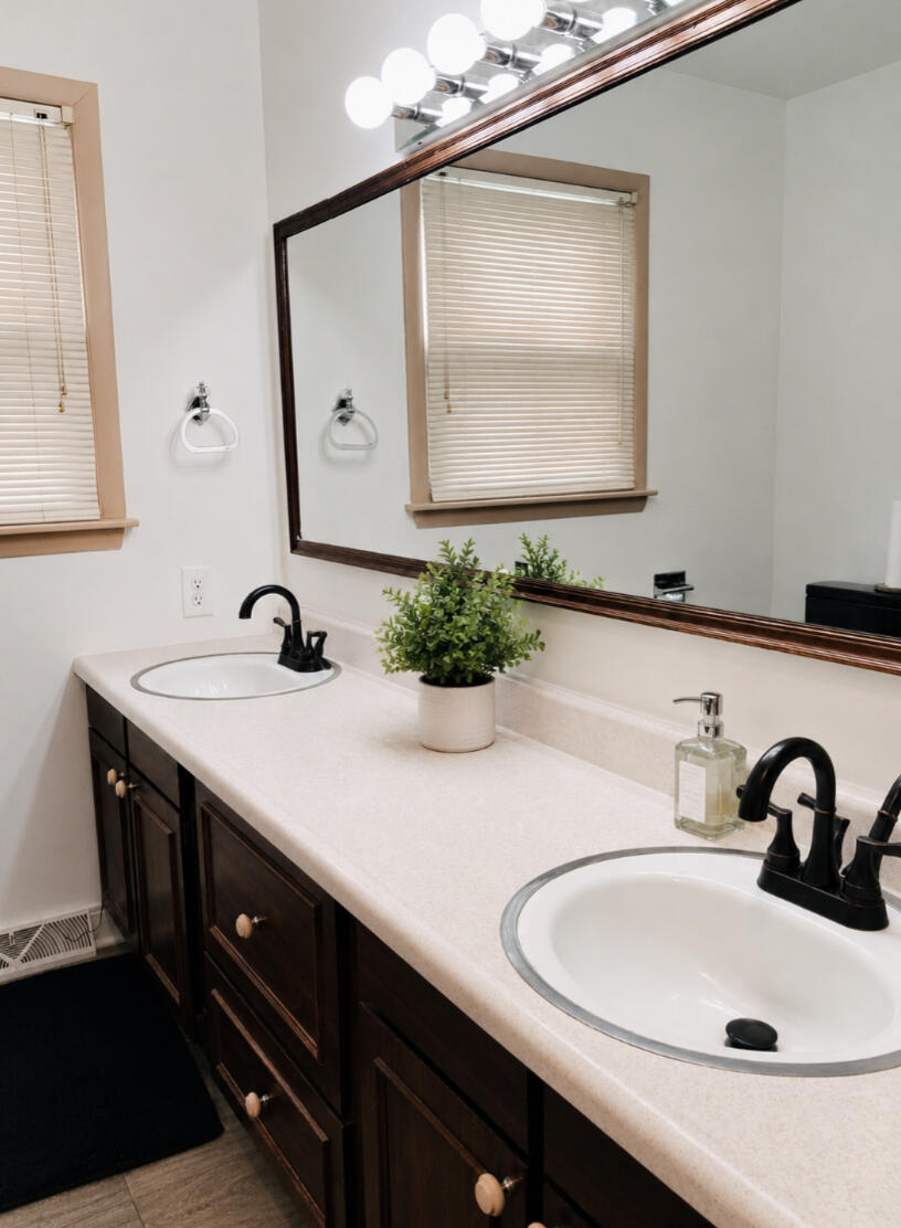 118 Minter Drive Griffith, IN 46319 - Photo 9 of 22 a bathroom with a double vanity sink and a mirror
