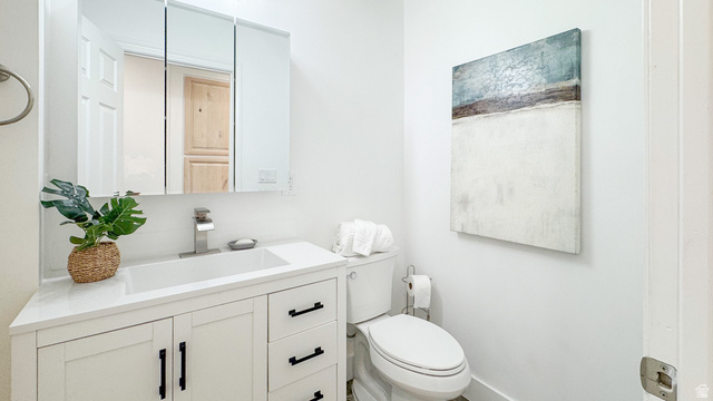 120 North 1230 E Street Springville, UT 84663 - Photo 14 of 60 Bathroom featuring a white vanity with black hardware, integrated sink, and a wall-mounted medicine cabinet