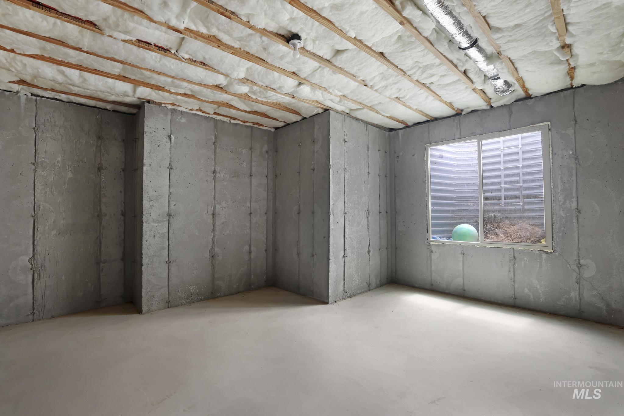 866 Quartz Road Kimberly, ID 83341 - Photo 42 of 48 Unfinished basement space featuring concrete walls and flooring, an egress window, and insulated ceiling joists
