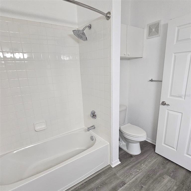3599 Conroy Road, Unit 934 Orlando, FL 32839 - Photo 6 of 18 a bathroom with a toilet and a bathtub