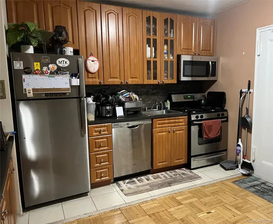 a kitchen with stainless steel appliances granite countertop a refrigerator and a stove